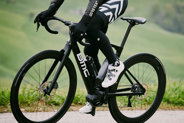 A cyclist wearing arm and leg warmers